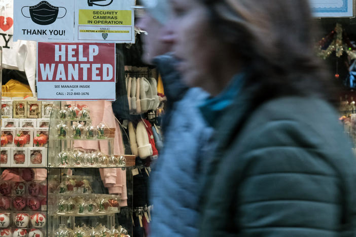 A 'help wanted' sign is displayed in a window of a store in Manhattan, New York City, on Dec. 2, 2022. U.S. employers added an unexpectedly strong 517,000 jobs in January, showcasing the labor market is red-hot. The unemployment rate fell to its lowest level in more than half a century.