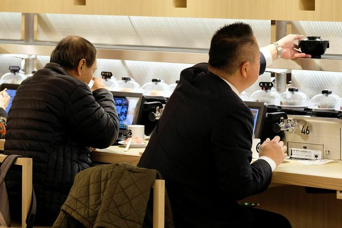 Customers dine at a Japanese conveyor belt sushi restaurant restaurant in Tokyo on Jan. 22, 2020.