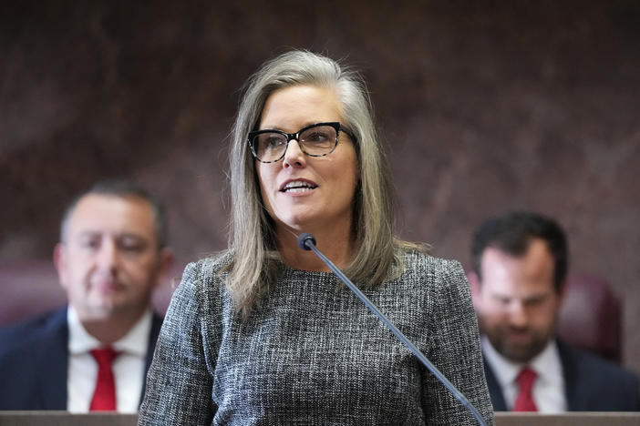 Democratic Arizona Gov. Katie Hobbs, middle, is flanked behind by Arizona House Speaker Ben Toma, left, and Arizona Senate President Warren Petersen, right, at Hobbs' state of the state address on Jan. 9, 2023, in Phoenix.