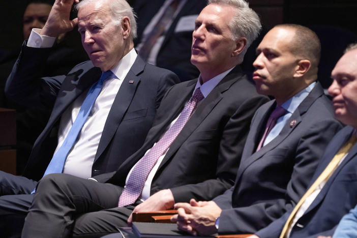 President Biden and Speaker Kevin McCarthy listen to a sermon as they sit together at the National Prayer Breakfast on Feb. 2.