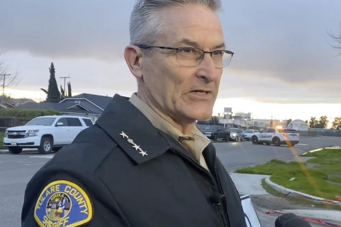 Sheriff Mike Boudreaux speaks to the media near the scene of a fatal shooting in Visalia, Calif., on Jan. 16. Boudreaux said Friday that two gang members suspected in the massacre of six people last month in central California have been arrested, one after a gunbattle.