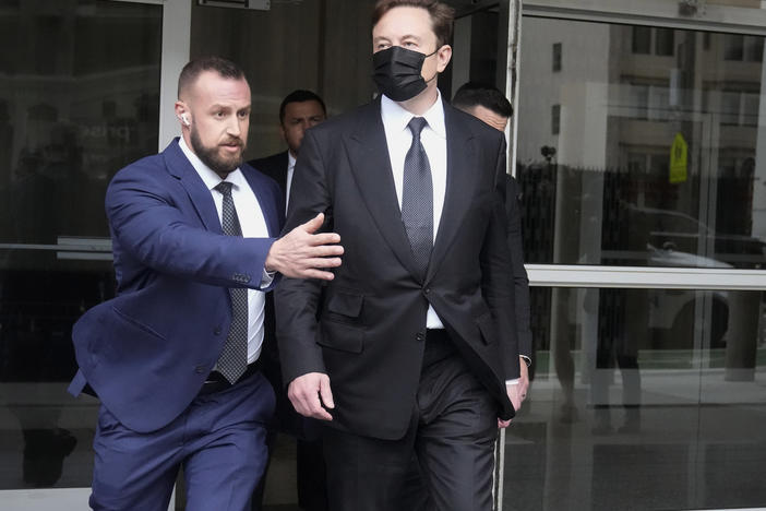 Elon Musk, center, leaves a federal courthouse in San Francisco on Feb. 3. A high-profile trial focused on a 2018 tweet about the financing for a Tesla buyout that never happened drew a surprise spectator for Friday's final arguments — Elon Musk, the billionaire who is being accused of misleading investors with his usage of the Twitter service he now owns.