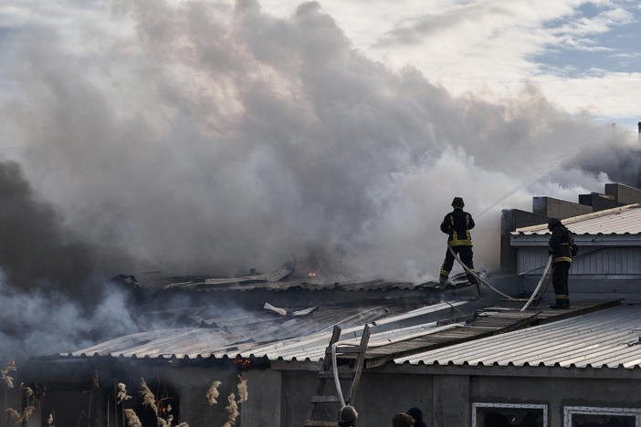 Ukrainian State Emergency Service firefighters put out a fire after Russian shelling hit an industrial area in Kherson, Ukraine, on Friday.