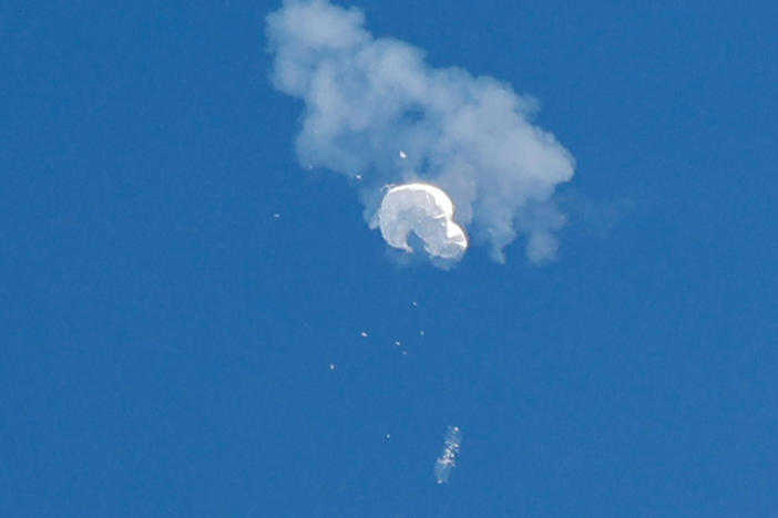 The suspected Chinese spy balloon drifts to the ocean after being shot down off the coast in Surfside Beach, S.C., on Saturday.