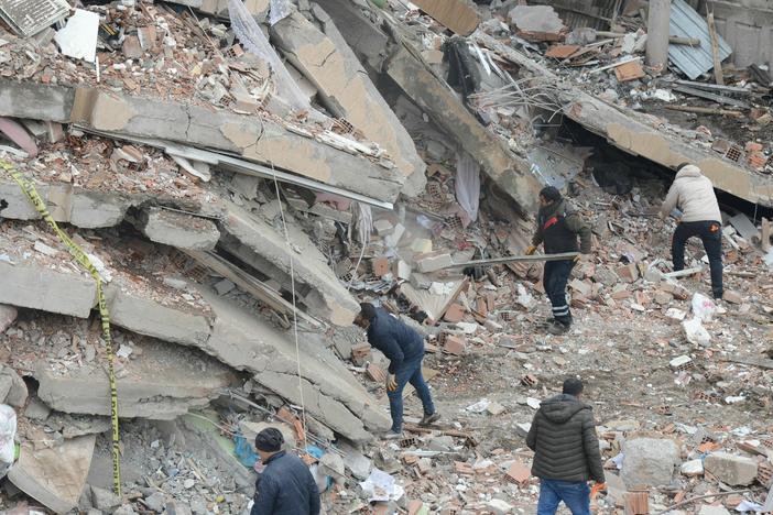 Rescue workers and volunteers conduct search and rescue operations in the rubble of a collapsed building in Diyarbakir, Turkey, after Monday's 7.8 magnitude earthquake.