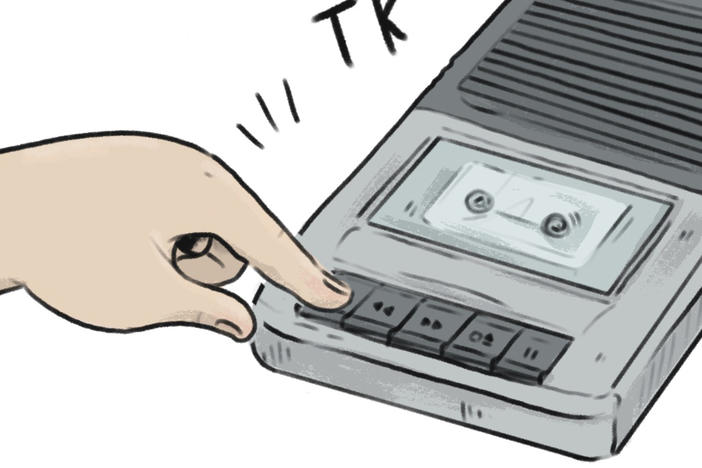 A child presses play on an audiobook cassette tape player.