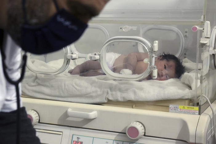 A baby girl who was born under the rubble caused by an earthquake that hit Syria and Turkey receives treatment inside an incubator at a children's hospital in the town of Afrin in Syria's Aleppo province on Tuesday. Residents in a northwest Syrian town discovered a crying infant whose mother gave birth to her while buried underneath the rubble of a five-story apartment building.
