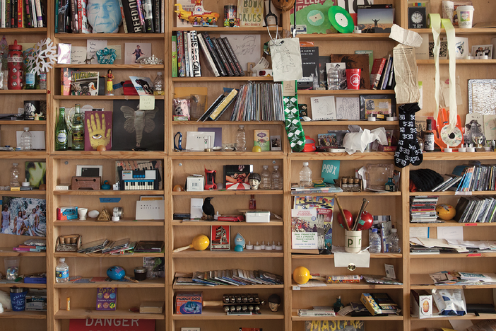 The bric-a-brac-stacked shelves of the Tiny Desk.