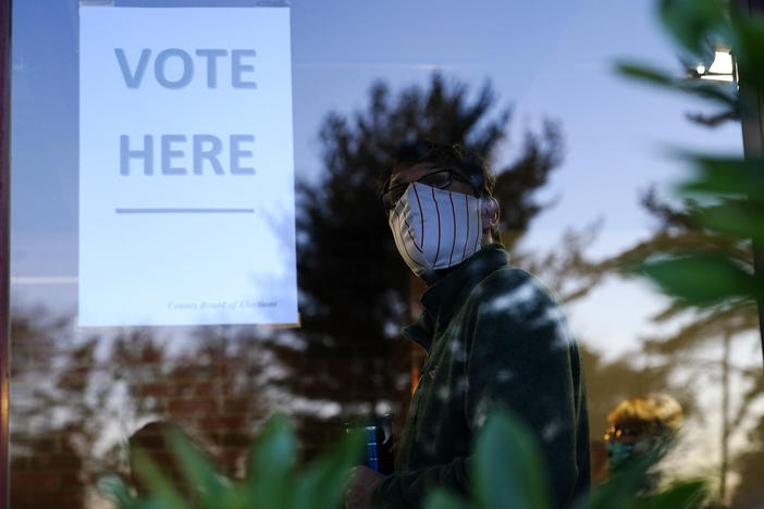 A voter lines up in a polling place to cast a ballot for the 2020 general election in Springfield, Pa., which is located in the Philadelphia suburb of Delaware County.