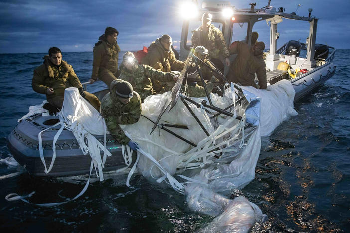 This image provided by the U.S. Navy shows sailors assigned to Explosive Ordnance Disposal Group 2, recovering a high-altitude surveillance balloon off the coast of Myrtle Beach, S.C., on Sunday.