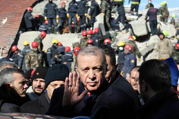 Turkish President Recep Tayyip Erdogan tours the site of destroyed buildings during his visit to the city of Kahramanmaras, in southeast Turkey, on Wednesday, two days after the severe earthquake that hit the region.