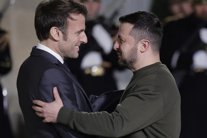 French President Emmanuel Macron, left, welcomes Ukrainian President Volodymyr Zelenskyy at the Elysee Palace before a working diner with German Chancellor Olaf Scholz, Wednesday, Feb. 8, 2023 in Paris.