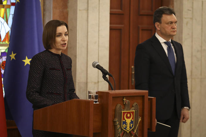 Moldovan Prime Minister designate Dorin Recean waits as President Maia Sandu (left) announces he is appointed to form a new government in Chisinau, Moldova, on Friday.