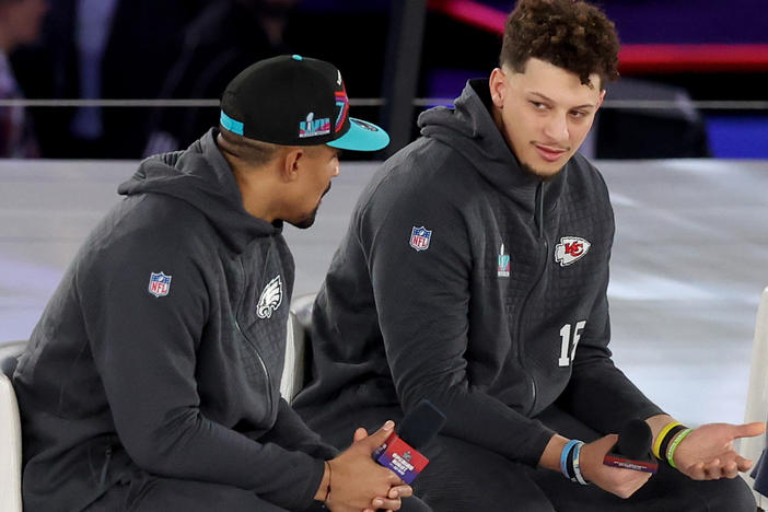 Jalen Hurts (left) of the Philadelphia Eagles talks with Patrick Mahomes  of the Kansas City Chiefs during Super Bowl LVII Opening Night at Footprint Center on Monday in Phoenix.