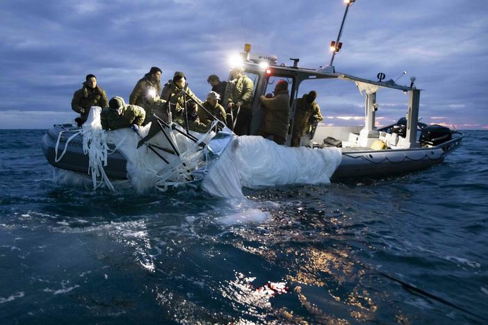 Sailors recover a high-altitude surveillance balloon in the waters off the coast of Myrtle Beach, S.C., on Feb. 5, after a fighter jet shot the balloon out of the sky.