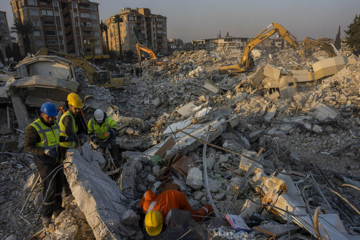 Members of a search and rescue operation work Sunday on an area that collapsed during the earthquake in Antakya, in southeastern Turkey. Disaster recovery experts say ordinary people are crucial to saving lives.