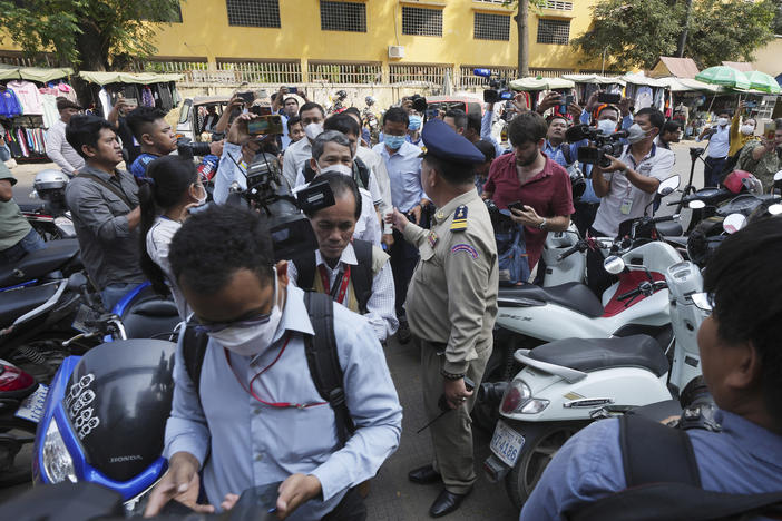 Authorities arrive at the Voice of Democracy office in Phnom Penh, Cambodia on Monday, Feb. 13.