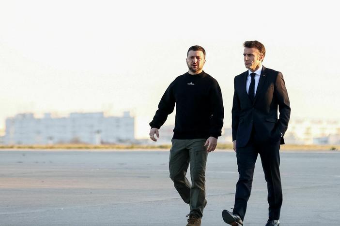 Ukrainian President Volodymyr Zelenskyy (left) walks with French President Emmanuel Macron on the tarmac of Vélizy-Villacoublay airbase as they prepare to board a flight together, en route to Brussels for a summit at European Parliament, on Feb. 9. Zelenskyy made a surprise Europe tour last week.