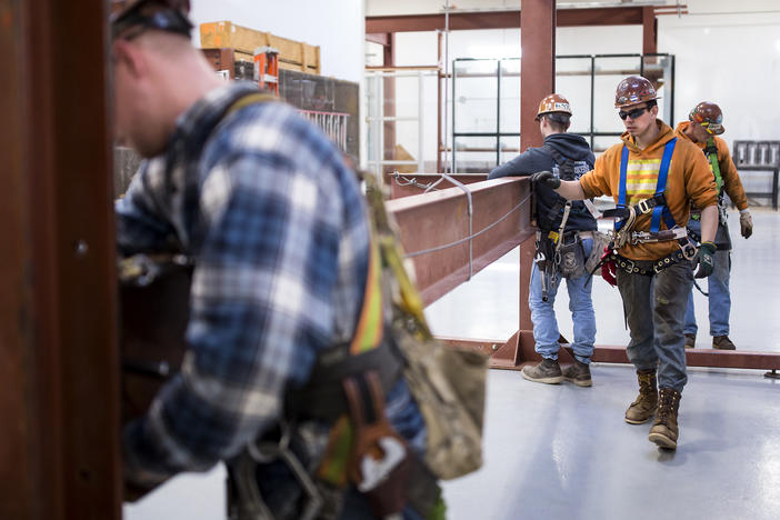 In 2018, Garret Morgan (center) was training as an ironworker near Seattle. Five years later, he says he made the right career choice: "I'm loving it every day."