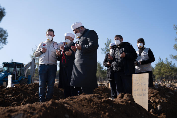 A funeral ceremony is performed at a mass grave site in Kahramanmaras, Turkey, where thousands of bodies from the earthquake are already buried and more graves are still being dug.