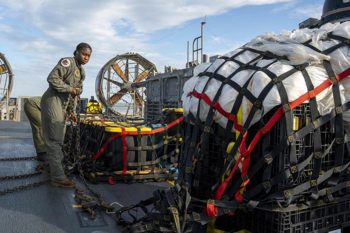 Sailors prepare material recovered in the Atlantic Ocean from a high-altitude balloon Friday for transport. The U.S. military says it has succeeded in recovering "significant debris" from a Chinese balloon that was shot down off of the South Carolina coast.
