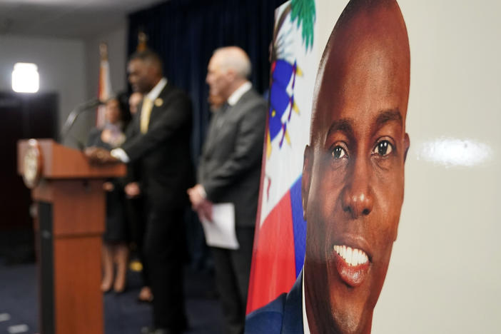 An image of Haitian President Jovenel Moïse, right, is displayed as Markenzy Lapointe, U.S. Attorney for the Southern District of Florida, speaks speaks during a news conference, Tuesday, Feb. 14, 2023, in Miami.