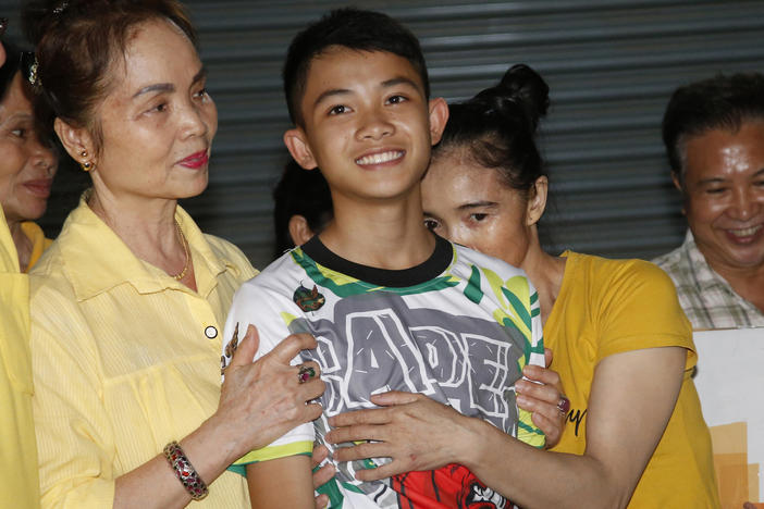 Relatives of Duangphet "Dom" Phromthep, one of the boys rescued from the flooded cave in northern Thailand, greet him as he arrives home in the Mae Sai district, Chiang Rai province, northern Thailand, in 2018.