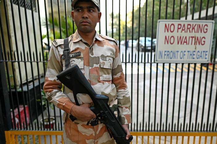 A Border Police officer stands guard outside the office building where Indian tax authorities raided BBC's office in New Delhi.