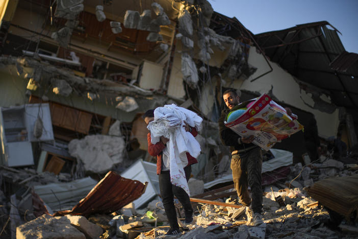 Residents remove their belongings from their destroyed house in Samandag, in southern Turkey, on Thursday. The number of people killed in the Feb. 6 earthquakes that devastated parts of southern Turkey and northern Syria continues to rise.