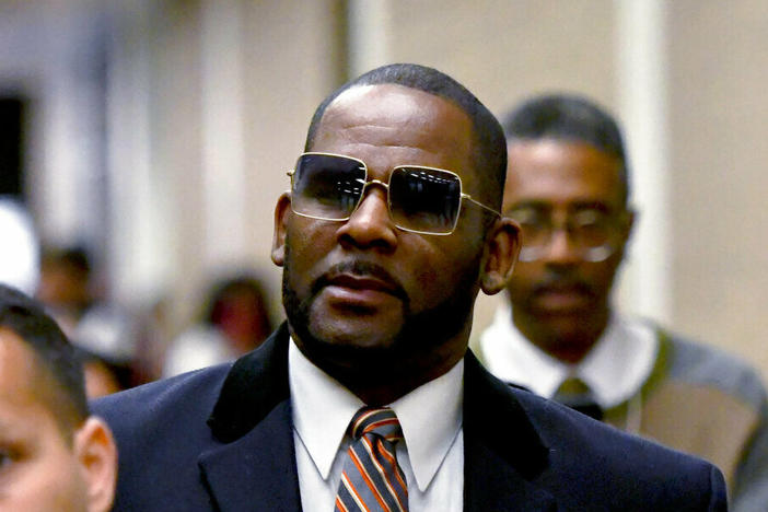 R. Kelly, center, leaves the Daley Center after a hearing in his child support case in May 2019 in Chicago.