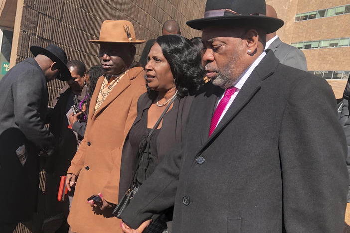 Attorney Ben Crump (from left) Tyre Nichols' mother, RowVaughn Wells, and stepfather, Rodney Wells, exit the courthouse in Memphis after five former Memphis police officers pleaded not guilty Friday to second-degree murder and other charges in Nichols' death.