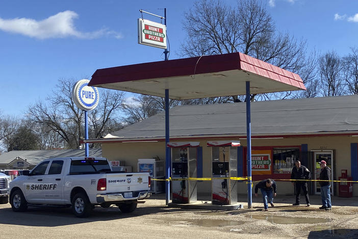 Law enforcement personnel work at the scene of a shooting Friday in Arkabutla, Miss. Six people were fatally shot in the small town in rural Mississippi and authorities said they had taken a suspect into custody.
