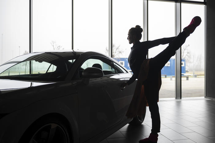 A ballet dancer warms up before an open rehearsal at the Audi automobile factory in Gyor, Hungary, on Thursday. The Ballet Company of Gyor is rehearsing at the factory after being forced to shutter its rehearsal hall in response to soaring energy prices.