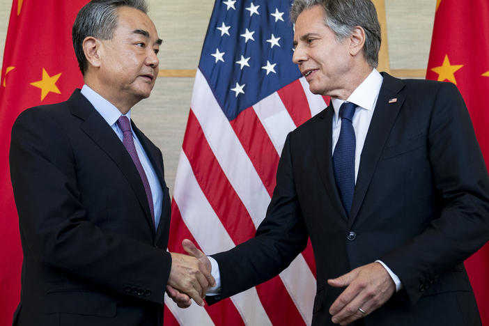 U.S. Secretary of State Antony Blinken shakes hands with China's top diplomat Wang Yi during a meeting in Nusa Dua on the Indonesian resort island of Bali on July 9, 2022.