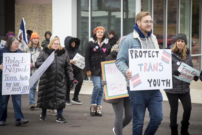 Protestors calling for LGBTQ rights stand outside a Pizza Ranch in Cedar Rapids, Iowa, where former Vice President Mike Pence is speaking on Feb. 15, 2023.