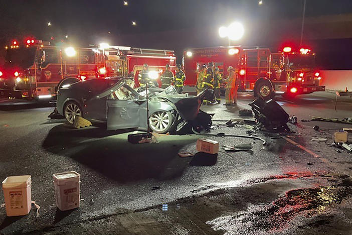 Fire officials said the Tesla driver was killed and a passenger was critically injured Saturday when the car plowed into the firetruck parked on a Northern California freeway.