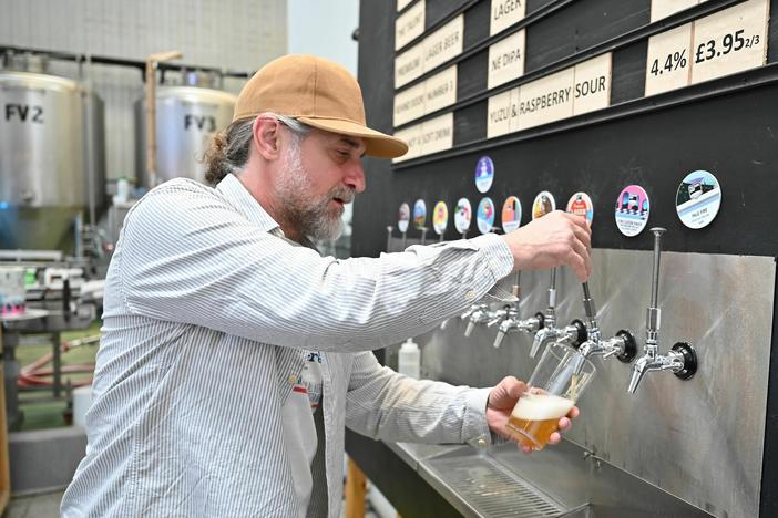 A worker pours a pint of beer at London's Pressure Drop Brewery, one of 61 U.K. employers that participated in a six-month trial of a four-day workweek.