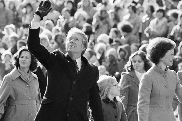 President Jimmy Carter waves to the crowd while walking with his wife, Rosalynn, and their daughter, Amy, along Pennsylvania Avenue from the Capitol to the White House following his inauguration in Washington, D.C., on Jan. 20, 1977. On the following day, he issued a pardon for people who had evaded the Vietnam War draft.