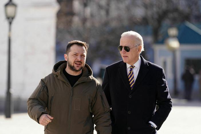 U.S. President Joe Biden walks next to Ukrainian President Volodymyr Zelensky on his surprise visit in Kyiv on Feb. 20.