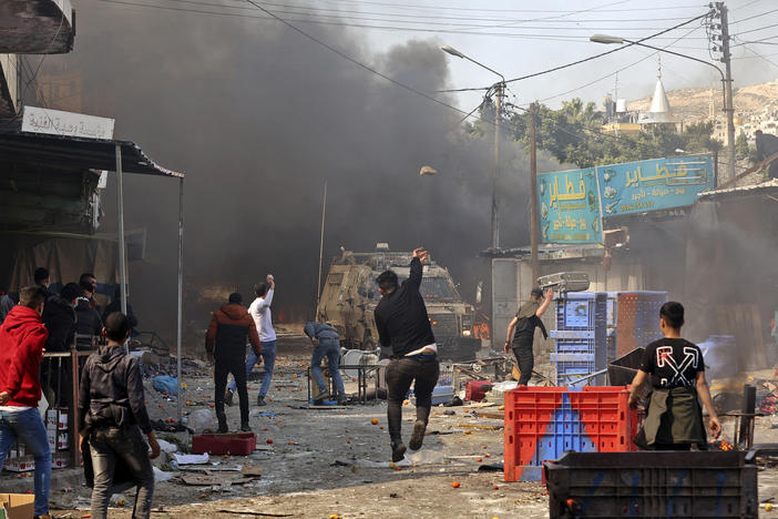 Palestinians clash with Israeli security forces during a raid in the occupied West Bank city of Nablus, on Feb. 22. The raid left scores of people hurt and killed 10 Palestinians. Israel's military says it suffered no casualties.