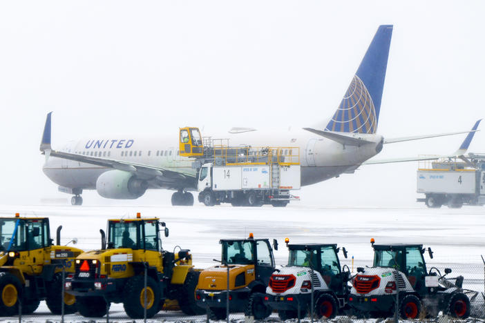 A United Airlines flight is de-iced before takeoff during a winter storm at Denver International Airport on Wednesday in Denver.