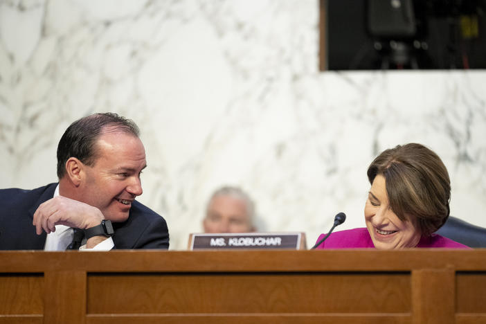 Sen. Mike Lee, R-Utah, left, speaks with Sen. Amy Klobuchar, D-Minn., during the Ticketmaster hearing on Jan. 24.