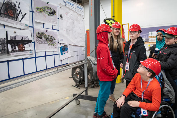 John Buettner (front), a 5th grader at Glen Lake Elementary School in Hopkins, Minn., looks at drawings of playground designs while on a tour at Landscape Structures with his classmates in Delano, Minn.