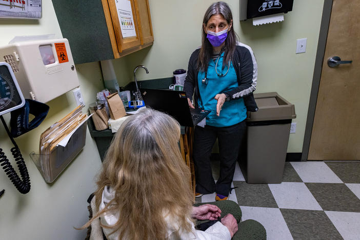Registered nurse Jamie Simmons speaks with a patient during an appointment at the Greater New Bedford Community Health Center in Massachusetts. The patient, whose first name is Kim, says buprenorphine has helped her stay off heroin and avoid an overdose for nearly 20 years.