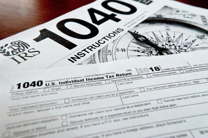 Internal Revenue Service tax forms are seen on a table. Black married couples are dealing with higher penalties compared with white married couples, a new report indicates.