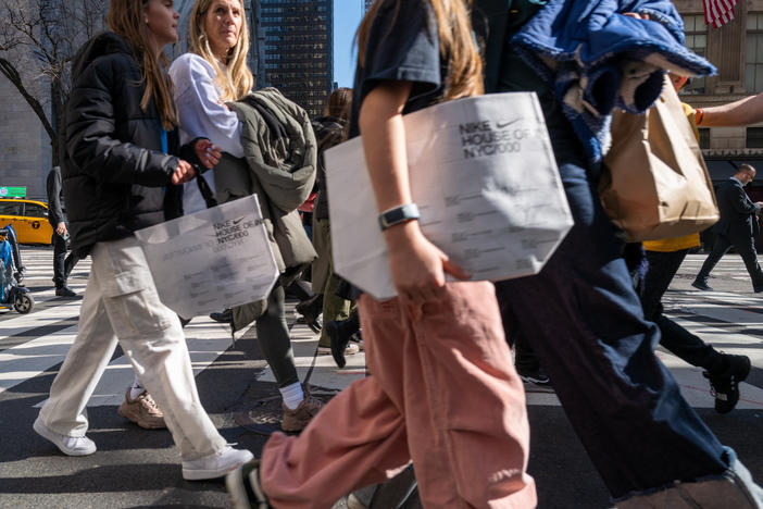 People walk along 5th Avenue in Manhattan, which is one of the nation's premier shopping streets, on Feb. 15, 2023. Consumer spending was unexpectedly strong last month. That's good for the economy – but not so good for inflation prospects.