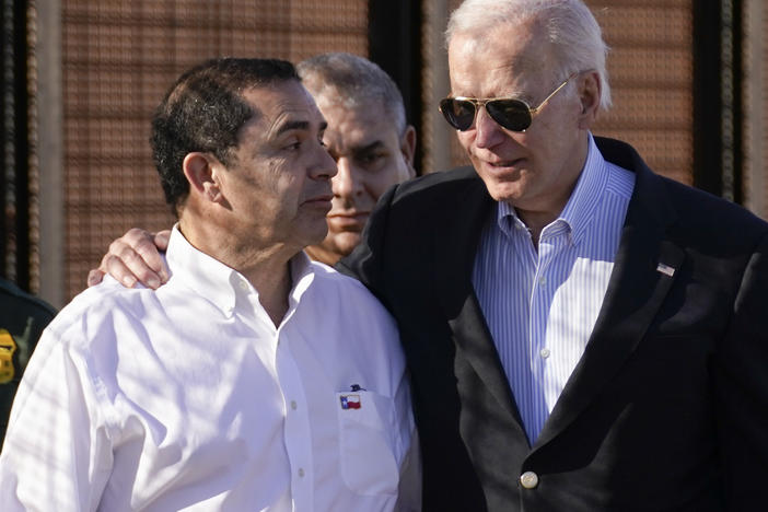 President Joe Biden talks with Rep. Henry Cuellar, D-Texas, left, as they walk along a stretch of the U.S.-Mexico border in El Paso Texas, last month.