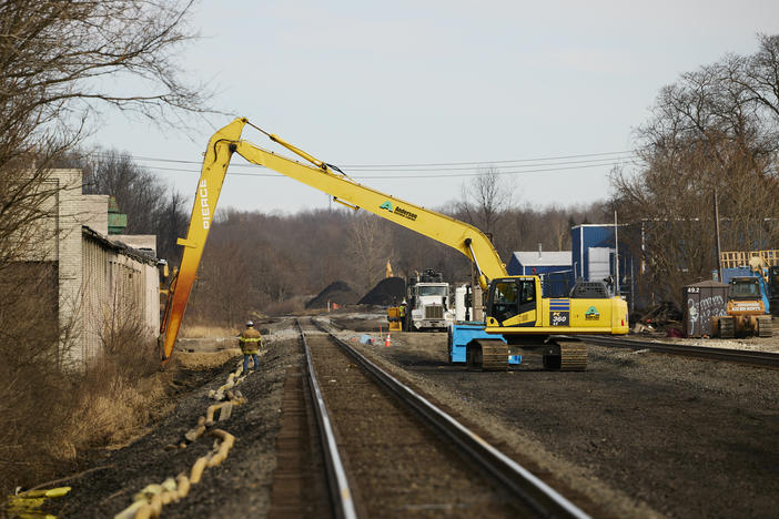 Workers remove contaminated dirt near the railroad tracks on February 14, 2023 in East Palestine, Ohio.