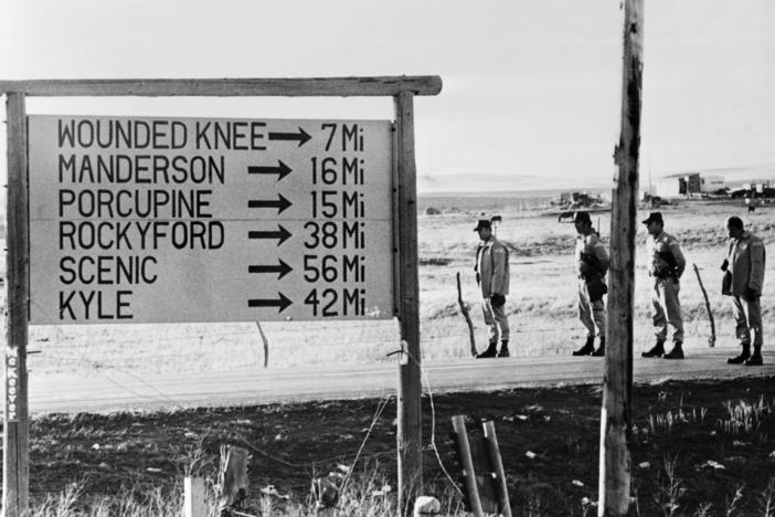 Federal troops block the road near Wounded Knee in March 1973.