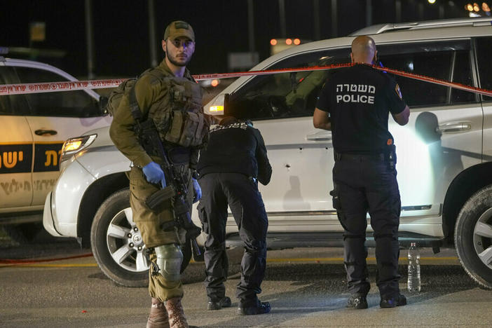Israeli security forces examine the scene of a shooting attack in the West Bank on Monday.